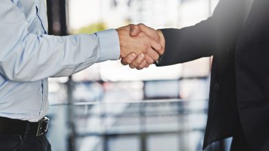 Cropped shot of two unrecognizable businessmen shaking hands in an office.
